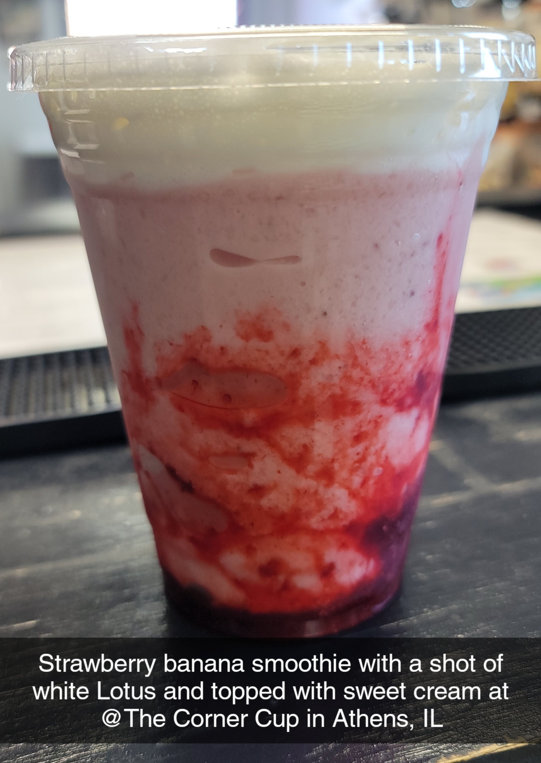 A strawberry banana smoothie topped with sweet cream